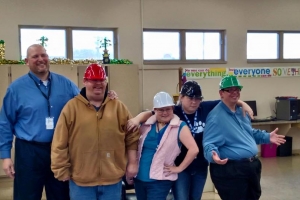 Group of smiling adults with hardhats
