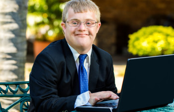 Young man in a tie with a laptop computer
