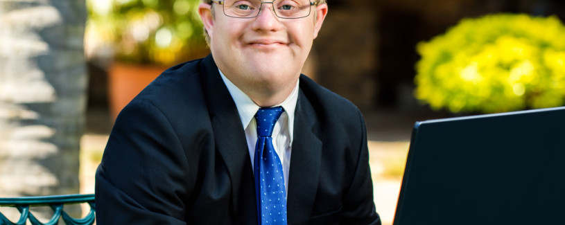 Young man in a tie with a laptop computer