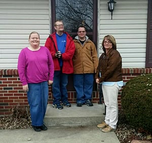 Roommates standing on the front step