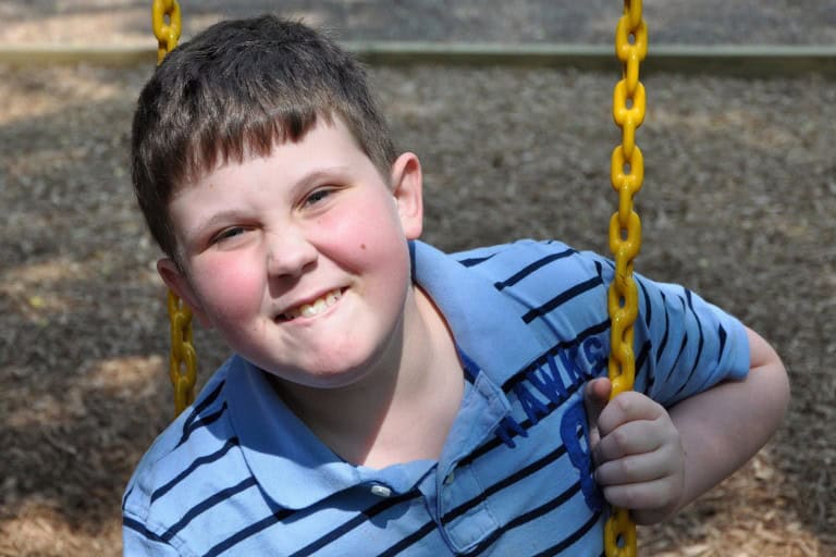 School age boy on swing